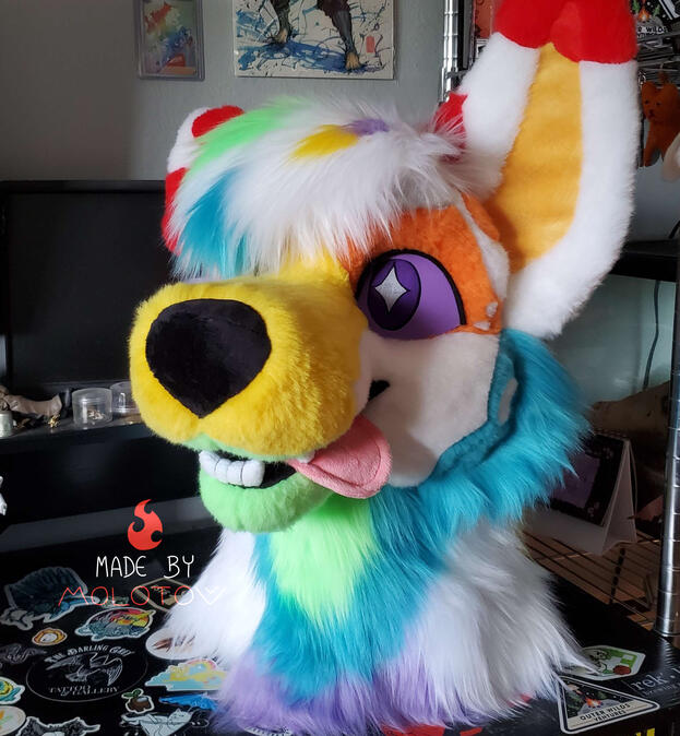 The fursuit head of Quartz, a colorful australian shepherd.