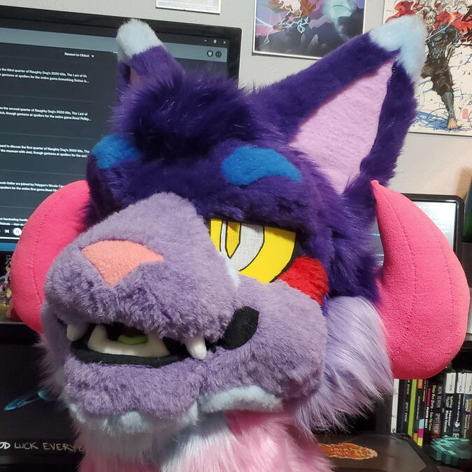 Bleeding Heart The head of Bleeding Heart, a brightly colored cat beast with curled pink horns.