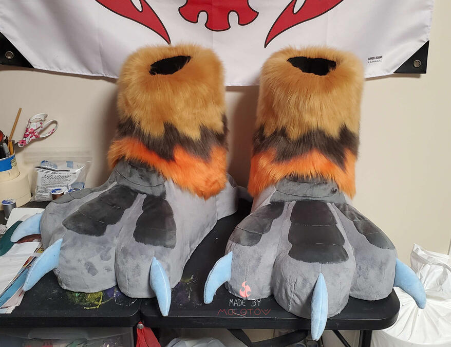 feet2 The same pair of feet paws. The paw on the left side of the image is turned on its side, showing the foam padding on the bottom.