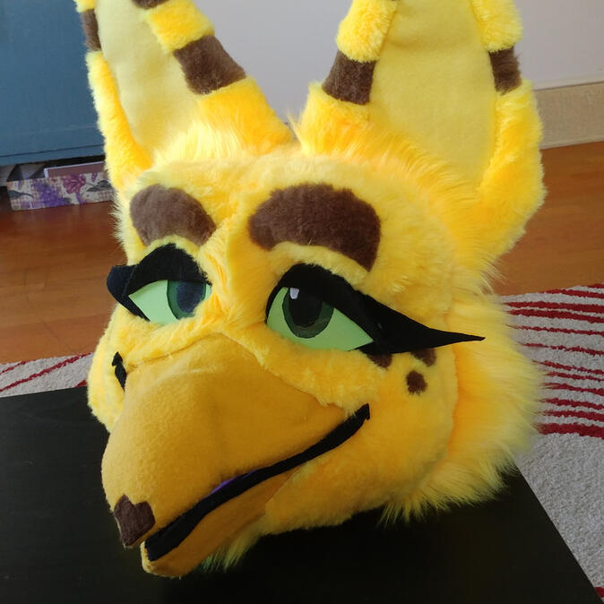 ani2 The head of Ani, a yellow avian creature.