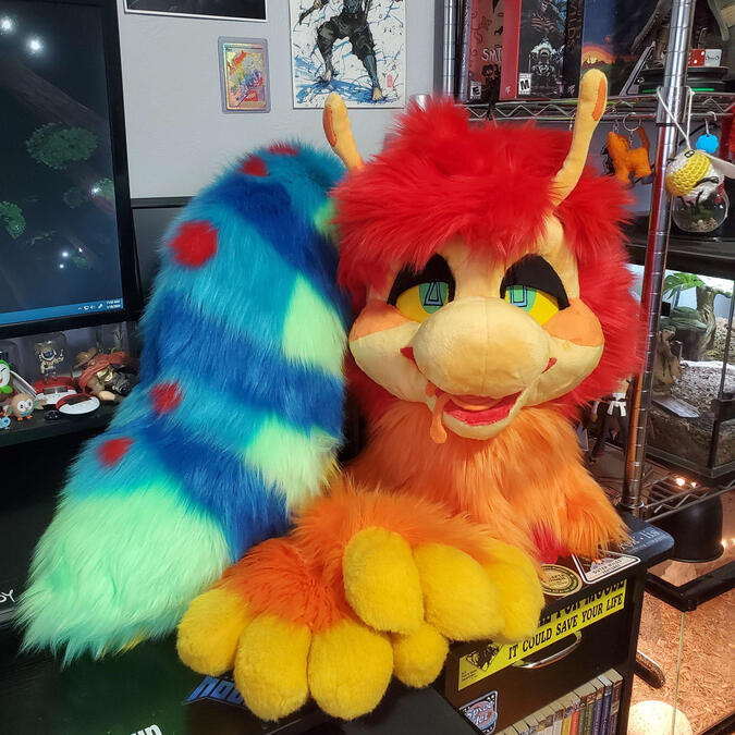 The head, paws, and tail of Squibz, a brightly colored cartoon-styled caterpillar.