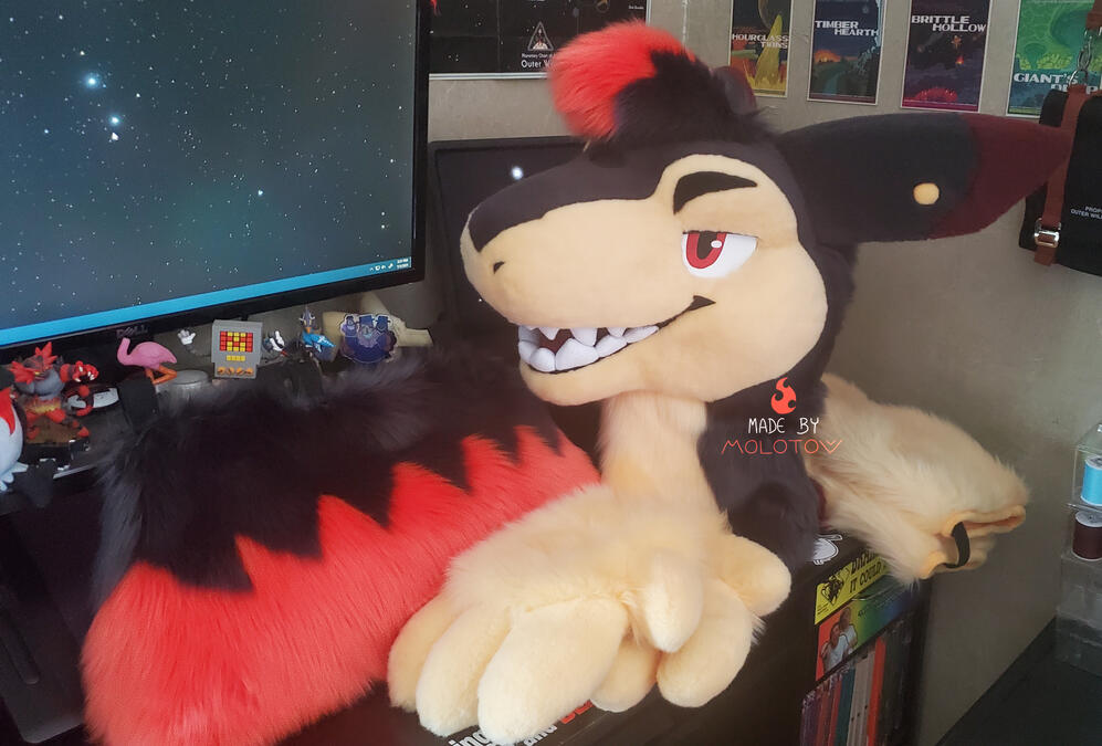 EMBER1 The fursuit head, handpaws, tail, and arm sleeves of Ember, a typhlosion character. His expression is confident, with eyes lidded and a toothy grin.